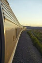 Passenger train traveling into the Arizona sunset Royalty Free Stock Photo