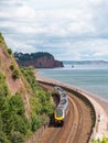 Passenger train travelling along the spectacular route towards Dawlish in south Devon UK