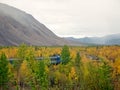 The passenger train through the forest. Railway through