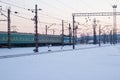 The passenger train travels through snow-covered rails