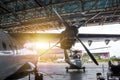 Passenger turboprop airplane and helicopter in the hangar. Rotorcraft and aircrafts under maintenance