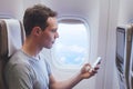 Passenger using mobile phone smartphone in the airplane