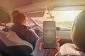 Passenger using smart phone app to rate a taxi or modern peer to peer ridesharing driver