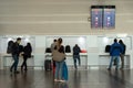 Passenger viewing flight information in the cell phone charging area at the airport in Bogota. Colombia.