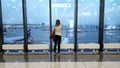 The passenger is waiting for the plane at the international airport, view through the window, travel concept