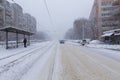 Passenger waiting in the tram station and the winter traffic