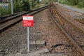 Passenger warning sign at railway train station stating do not trespass or penalty fine will be issued if you cross the rail line