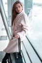 Passenger woman in airport waiting for air travel.