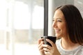 Passenger woman drinking coffee during a train travel