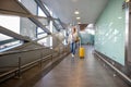 Passenger woman wearing a medical protective mask for prevent coronavirus walking with her luggage walking in almost airport