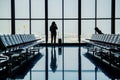 Passengers at the airport window talking by phone . Royalty Free Stock Photo