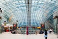 Passengers await a flight inside the futuristic glass structure of Frankfurt Airport train station. Frankfurt, Germany: August 16