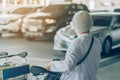 Passengers with big roller luggage stand to wait for the car to pick up