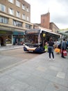 Passengers board a bus in Exeter, UK with the display showing a warning that face coverings must be worn