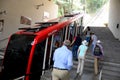 Passengers board funicular train tram at station for journey up mountain Tbilisi Georgia