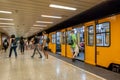 Passengers boarding the yellow train wagons of Budapest subway Royalty Free Stock Photo