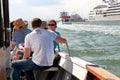 The passengers in the boat is traveling by Venetian Lagoon