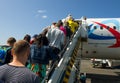 Passengers climb the ladder on the plane of airline Ural Airlines in Domodedovo airport