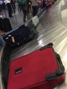 Passengers collect their case from baggage carousel