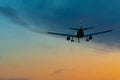 Passengers or commercial airplane flying above clouds in sunset light. Concept of fast travel holidays and business Royalty Free Stock Photo