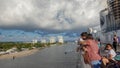 Passengers on a cruise ship leaving Port Everglades, in Ft. Lauderdale, Florida look out over the ocean channel with a luxury