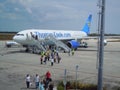 Passengers disembarking airliner at airport