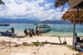 Passengers are embarked in a boat that is moored on the beach. Gili Island. Indonesia Royalty Free Stock Photo