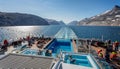 Passengers enjoying the hot tubs and arctic scenery on Hurtigrutens MS Fridtjof Nansen in Prince Christian Sound, South Greenland