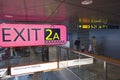 passengers at helsinki vantaa airport near sign of exit and baggage