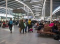 Passengers inside large modern railway terminal concourse