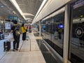 Passengers with luggage waiting for a Taoyuan International Airport MRT train on the Airport Terminal 1 platform in Royalty Free Stock Photo