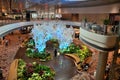 Passengers move around a green garden relaxing area inside Changi Airport terminal Singapore