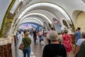Passengers in ornate underground passageway to metro platforms in St Petersburg Metro in St Petersburg, Russia