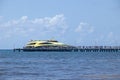 Passengers on the pier board the ferry