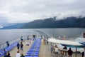 Passengers at rear of cruise ship enjoying sight of Norwegian Fjords