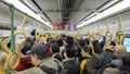 Passengers ride a crowded metro train in Kyoto