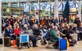 Passengers sat in Paddington Station waiting for trains in Paddington, London, UK Royalty Free Stock Photo