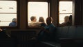 Passengers sitting inside a ferry with a view of the sea through the windows Royalty Free Stock Photo