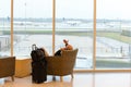 Passengers sitting with lugagge in airport