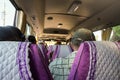 Passengers sitting in minibus, view from seat behind