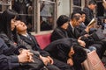 Passengers sleeping on a late night train in Hiroshima Japan