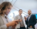 Passengers with smartphones standing at the subway station . Royalty Free Stock Photo