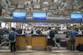 Passengers stand in line waiting for check-in at Singapore Changi Airport Royalty Free Stock Photo