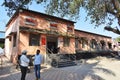 Passengers standing outside building of Uruli Railway station