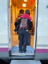 Passengers with suitcases and backpacks entering a train car. Vacation and travel concept Royalty Free Stock Photo