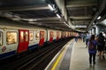 Passengers and train at a London Underground station Royalty Free Stock Photo