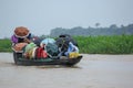 Sunamganj, Bangaldesh- October 11,2016: Passengers traveling by wooden boat in the rain and protecting by umbrella