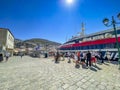 Passengers and travellers arrive and wait to embark to the Flying dolphin at the port of Hydra, Greece