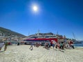 Passengers and travellers arrive and wait to embark to the Flying dolphin at the port of Hydra, Greece