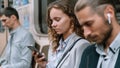 Passengers using smartphones in the subway car . Royalty Free Stock Photo